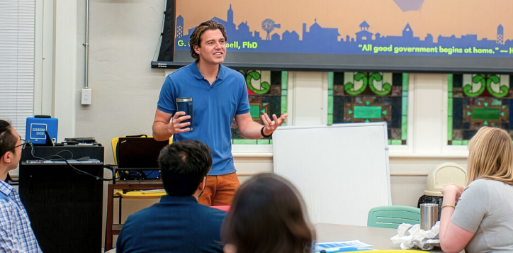 A faculty member teaching students in a classroom setting.