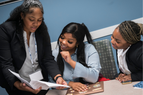 Faculty members collaborating in a professional setting.