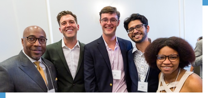Students and faculty networking at a School of Government event.