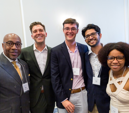 Students and faculty networking at a School of Government event.